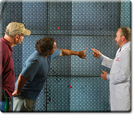 Photo of Dr. Edward Nelson uses the Hiperwall to magnify his micropallet arrays